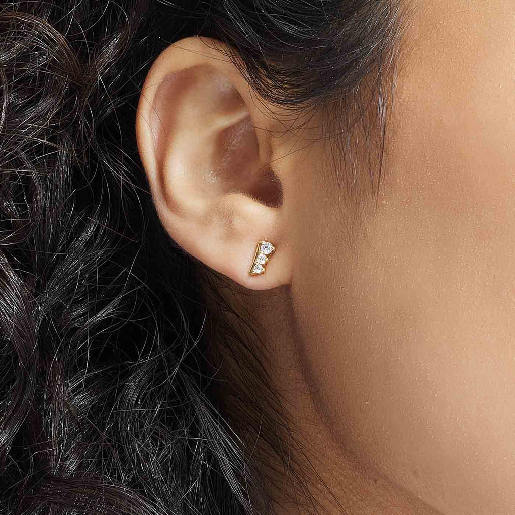 The Ecksand Asymmetrical Three-Diamond Stud Earrings shown with  in 