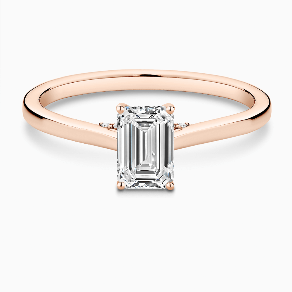 The Ecksand Solitaire Engagement Ring with Diamond Pavé Bridge and Hidden Diamond shown with Emerald in 14k Rose Gold