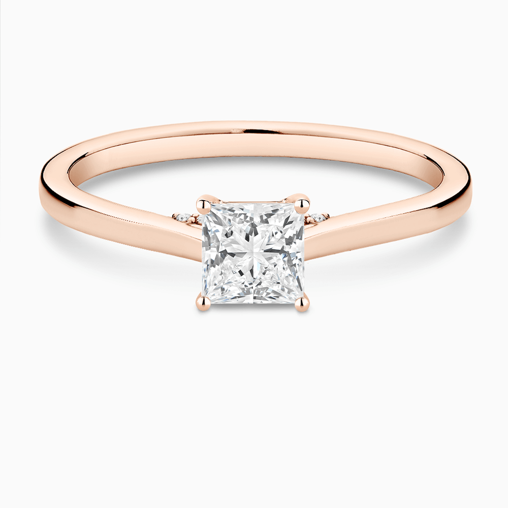 The Ecksand Solitaire Engagement Ring with Diamond Pavé Bridge and Hidden Diamond shown with Princess in 14k Rose Gold