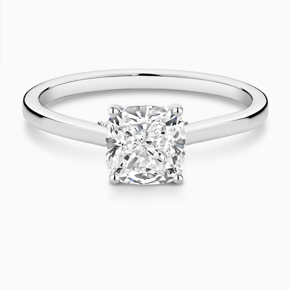 The Ecksand Solitaire Engagement Ring with Diamond Pavé Bridge and Hidden Diamond shown with Cushion in 18k White Gold