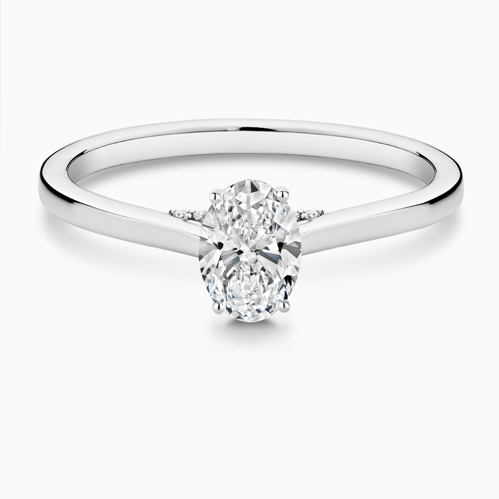 The Ecksand Solitaire Engagement Ring with Diamond Pavé Bridge and Hidden Diamond shown with Oval in 18k White Gold