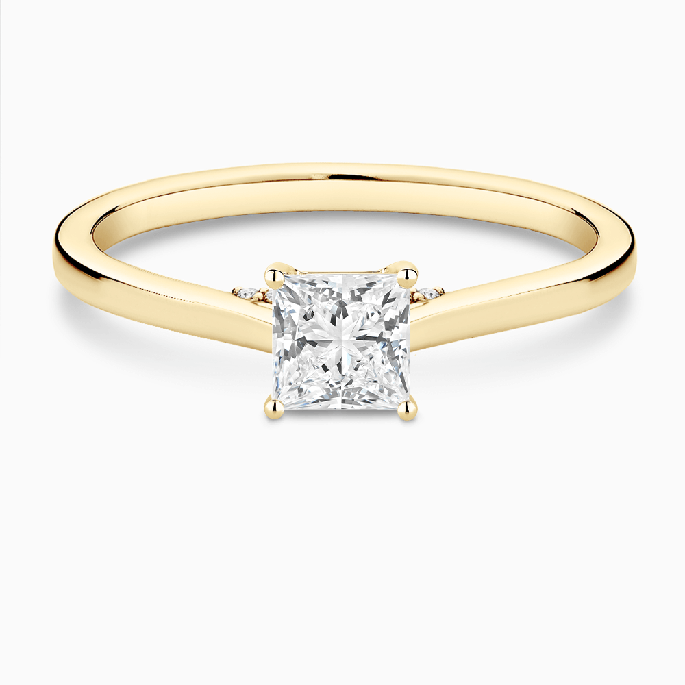 The Ecksand Solitaire Engagement Ring with Diamond Pavé Bridge and Hidden Diamond shown with Princess in 18k Yellow Gold