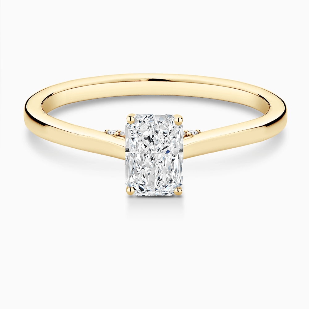 The Ecksand Solitaire Engagement Ring with Diamond Pavé Bridge and Hidden Diamond shown with Radiant in 18k Yellow Gold