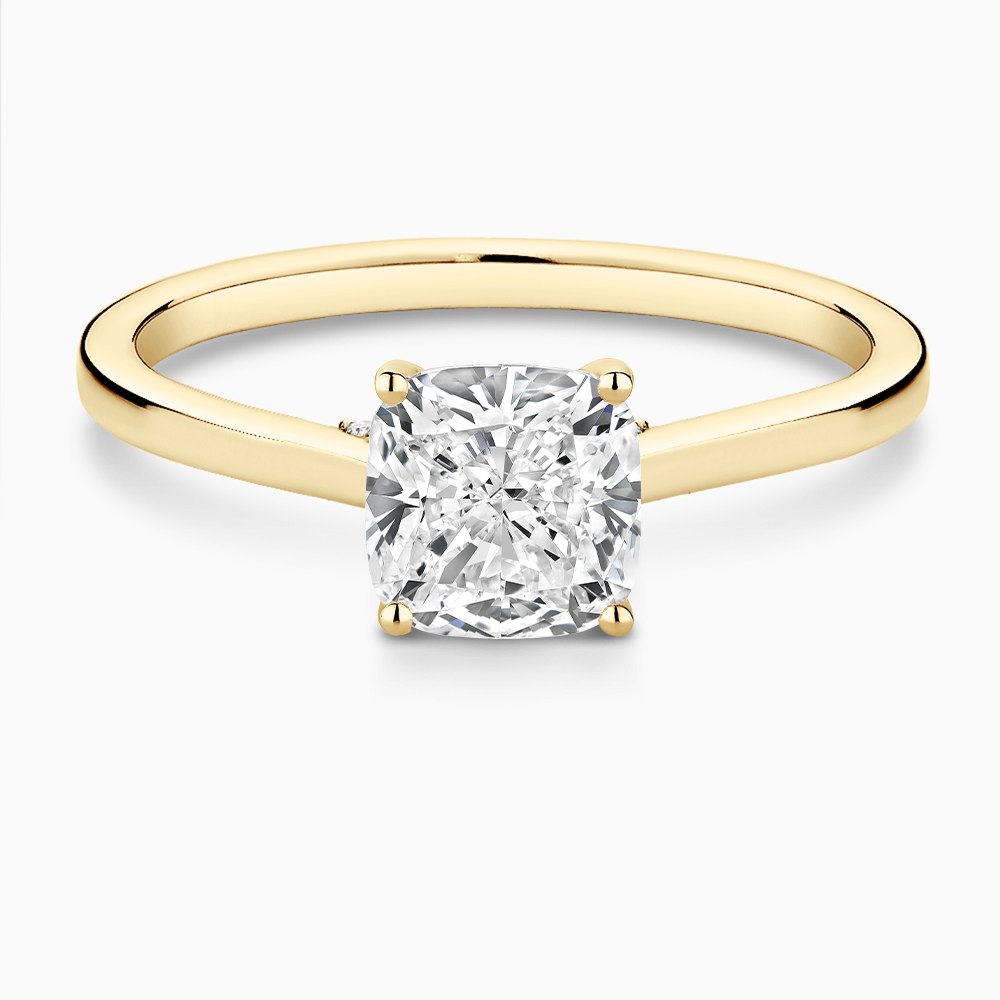 The Ecksand Solitaire Engagement Ring with Diamond Pavé Bridge and Hidden Diamond shown with Cushion in 18k Yellow Gold