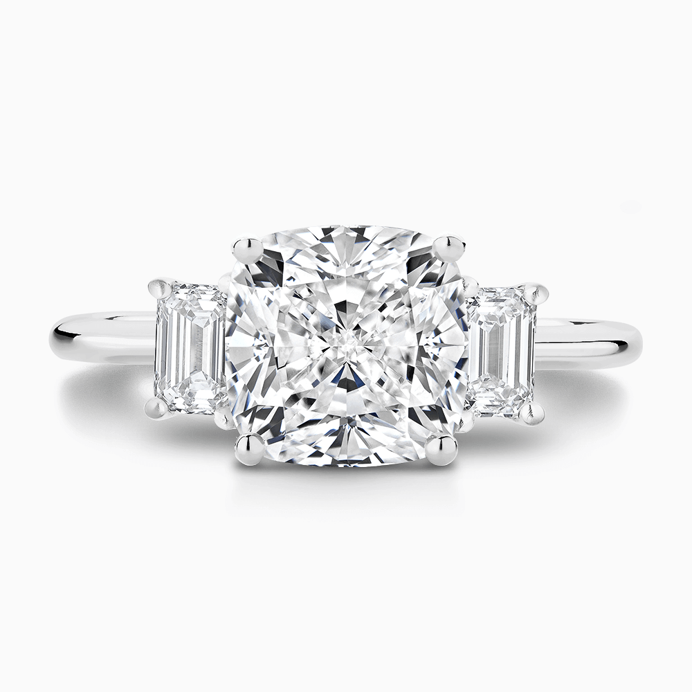 The Ecksand Three-Stone Diamond Engagement Ring with Basket Setting shown with Cushion in 18k White Gold