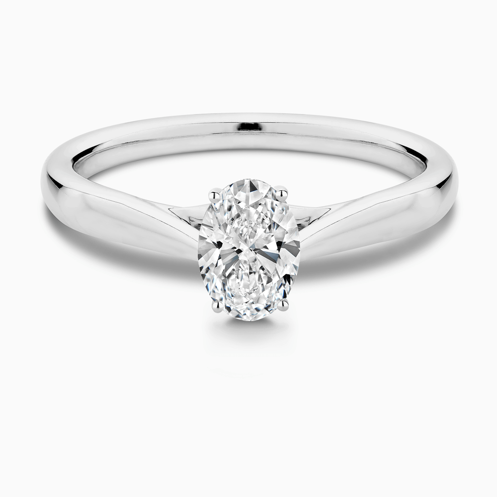The Ecksand Iconic Tapered Band Solitaire Diamond Engagement Ring with Secret Heart shown with Oval in 18k White Gold