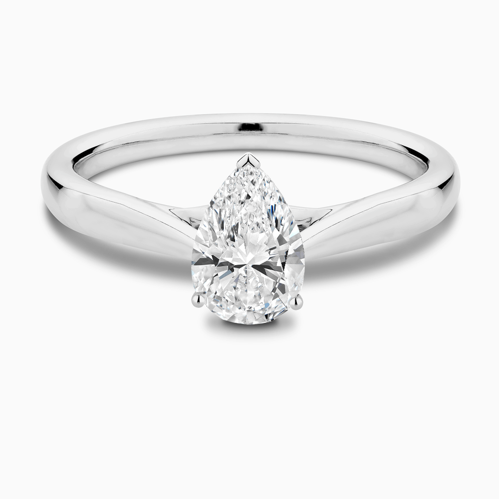 The Ecksand Iconic Tapered Band Solitaire Diamond Engagement Ring with Secret Heart shown with Pear in 18k White Gold