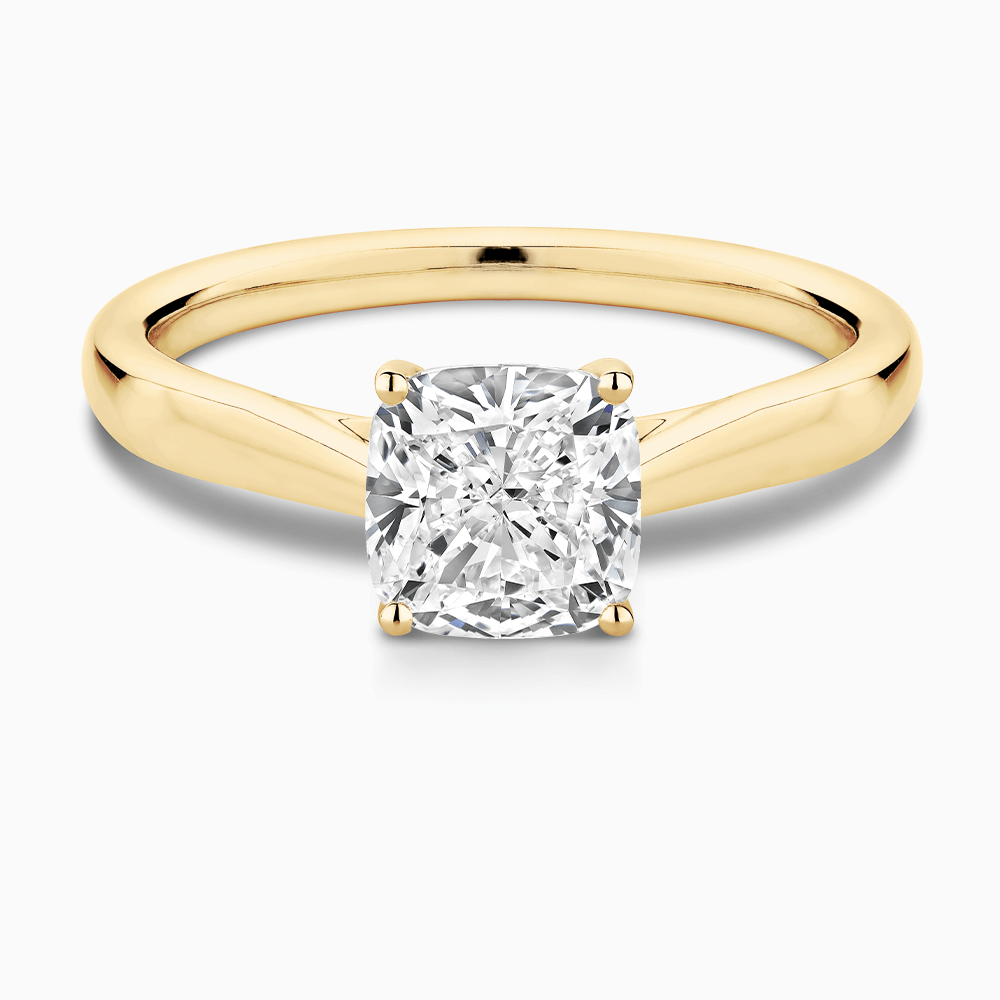 The Ecksand Iconic Tapered Band Solitaire Diamond Engagement Ring with Secret Heart shown with Cushion in 18k Yellow Gold