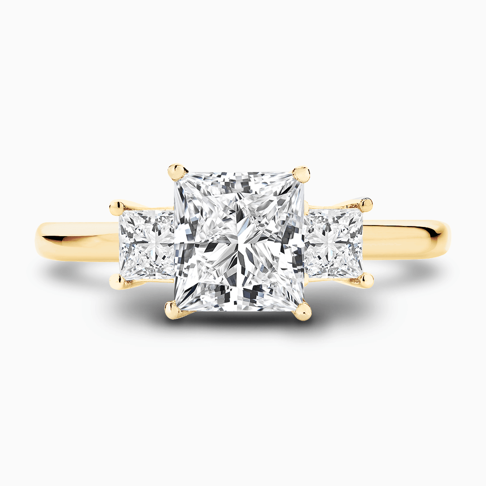 The Ecksand Three-Stone Diamond Engagement Ring shown with Princess in 18k Yellow Gold