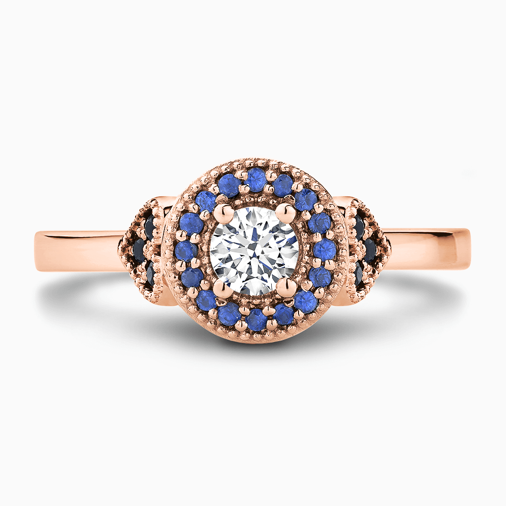 The Ecksand Diamond Engagement Ring with Blue Sapphire Halo and Side Stones shown with Round in 14k Rose Gold