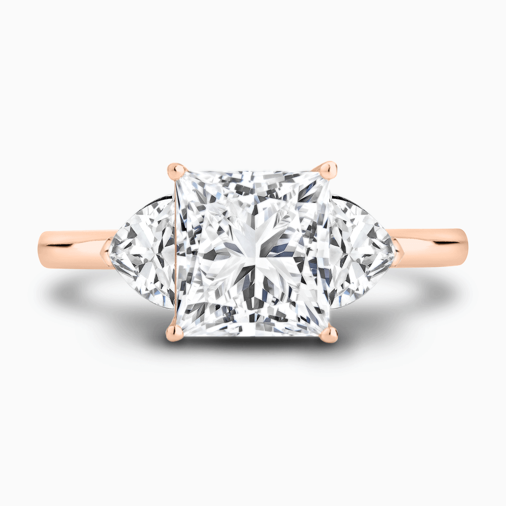 The Ecksand Three-Stone Diamond Engagement Ring with Trillion-Cut Side Diamonds shown with Princess in 14k Rose Gold