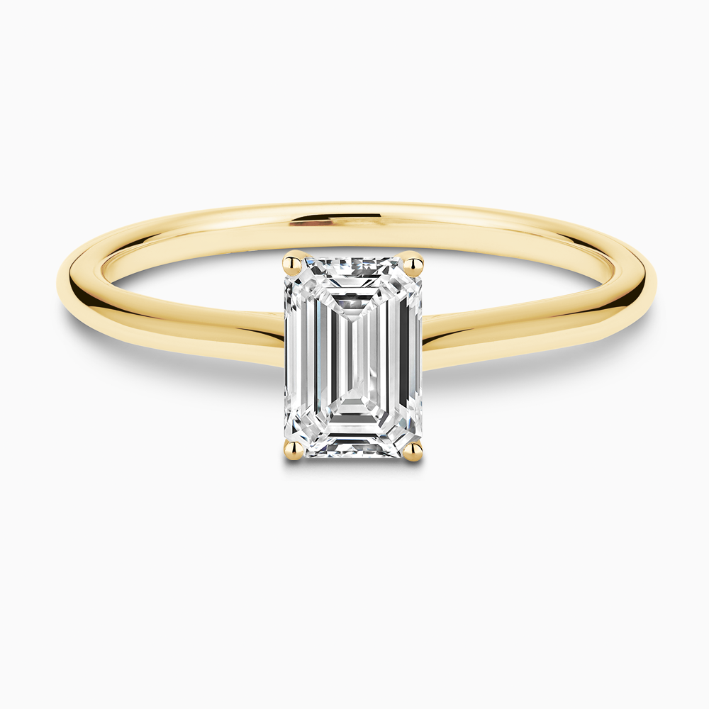 The Ecksand Iconic Diamond Engagement Ring with Diamond Bridge and Cathedral Setting shown with Emerald in 18k Yellow Gold