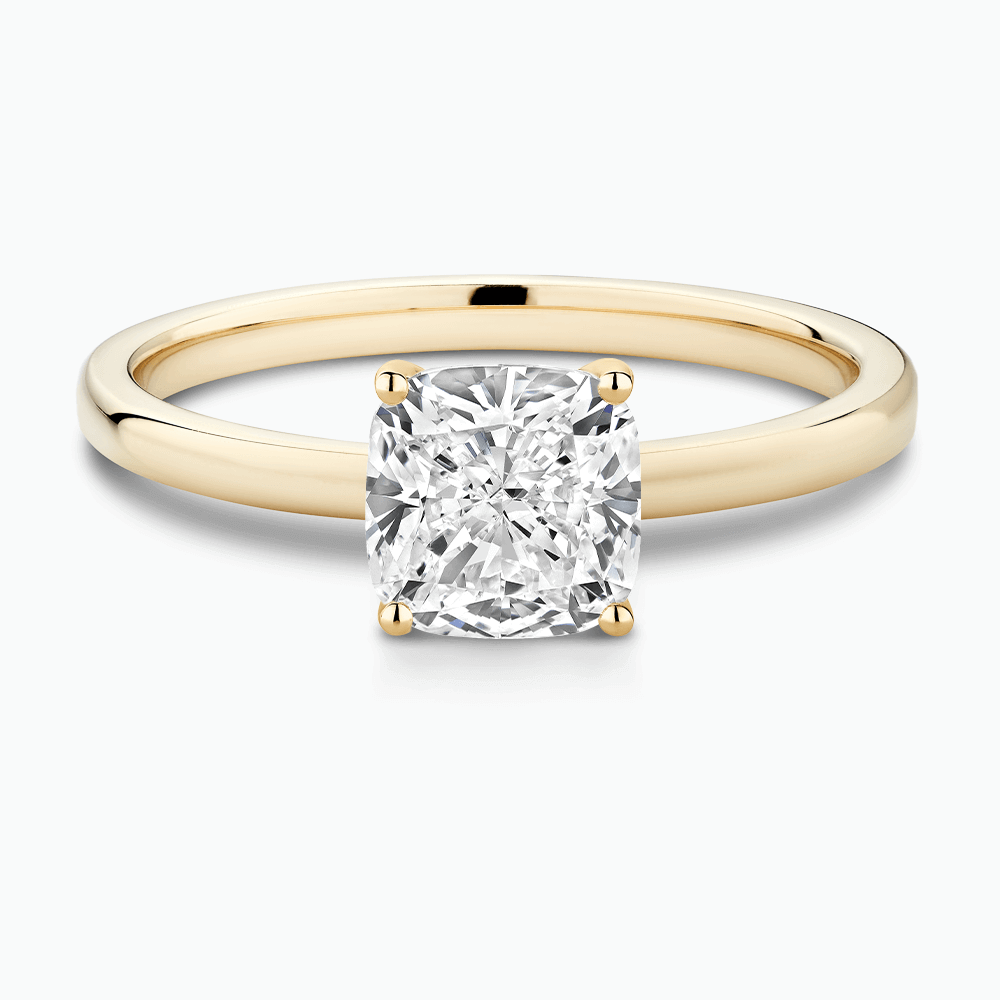 The Ecksand Solitaire Diamond Engagement Ring with Diamond Pavé Basket Setting shown with Cushion in 18k Yellow Gold
