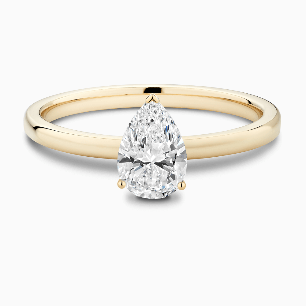 The Ecksand Solitaire Diamond Engagement Ring with Diamond Pavé Basket Setting shown with Pear in 18k Yellow Gold