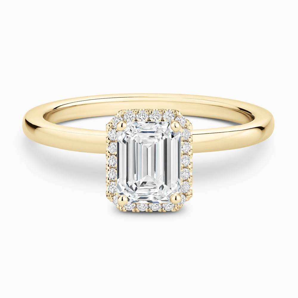The Ecksand Iconic Diamond Halo Engagement Ring with Plain Band shown with Emerald in 18k Yellow Gold