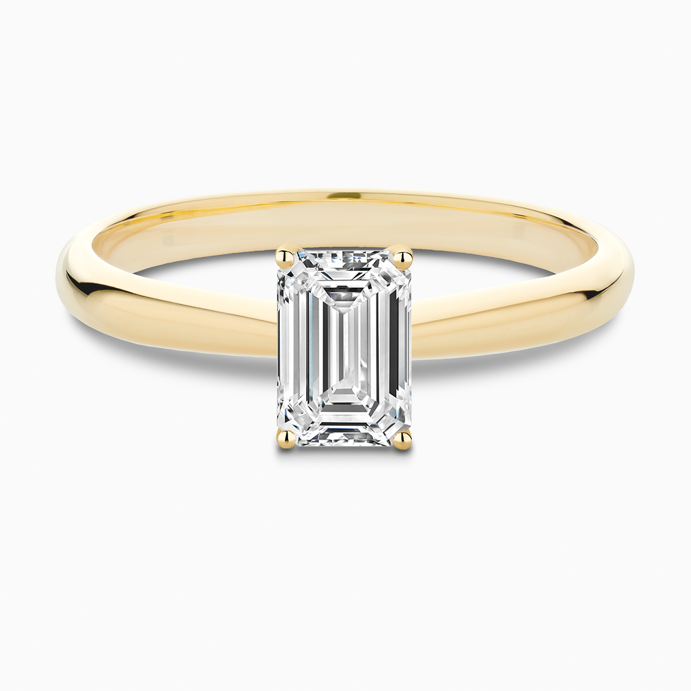 The Ecksand Tapered Diamond Engagement Ring with Basket Setting shown with Emerald in 18k Yellow Gold