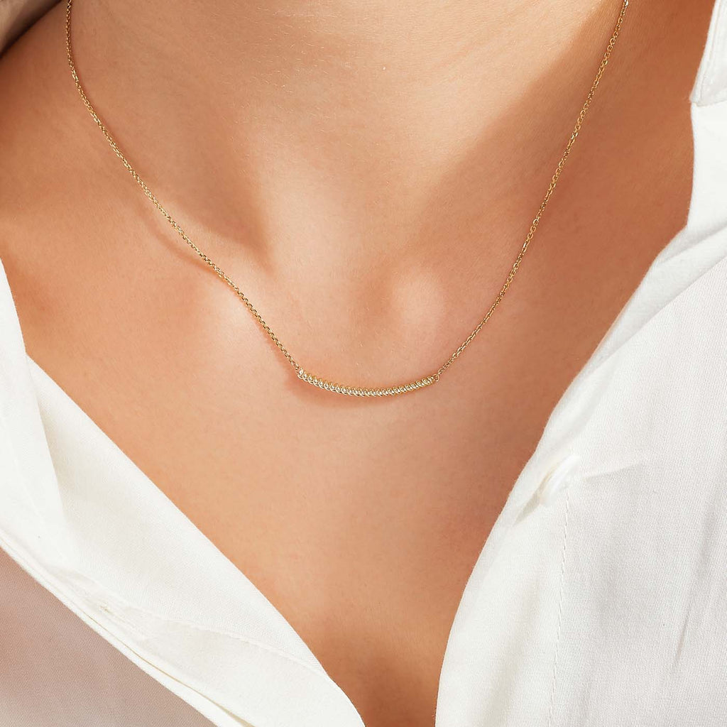 The Ecksand Twisted Gold Bar Necklace shown with  in 