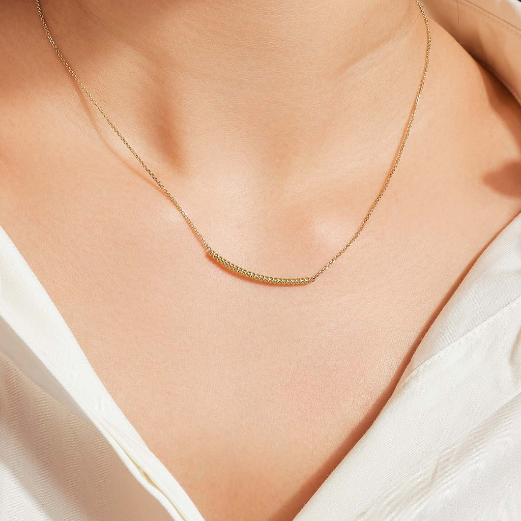 The Ecksand Twisted Gold Bar Necklace shown with  in 