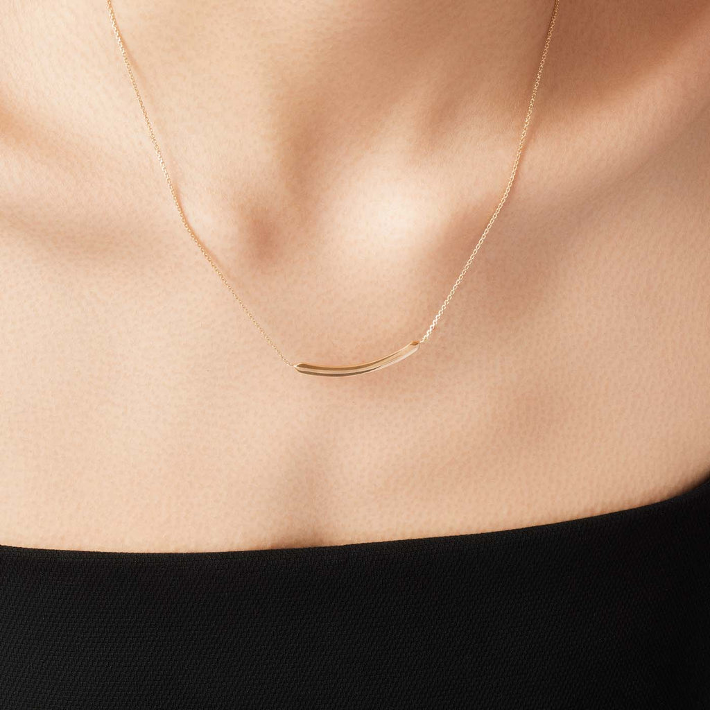 The Ecksand Duel Curved Gold Bar Necklace shown with  in 